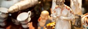 antique porcelain figures and other items at an estate sale