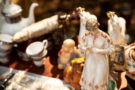 antique porcelain figures and other items at an estate sale