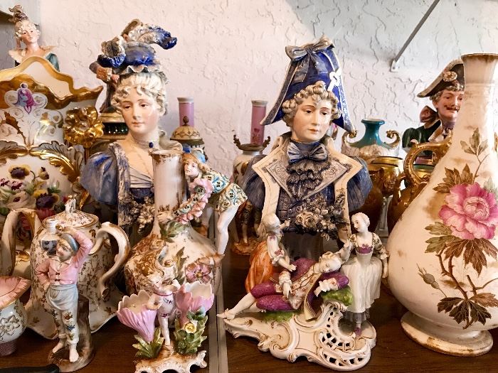 Porcelain figurines and vases displayed at an estate sale