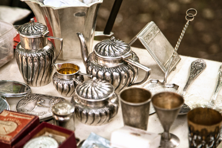 antique silver pots and utensils at an estate sale